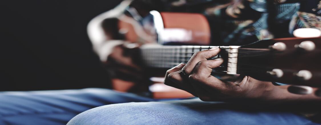 man playing guitar country